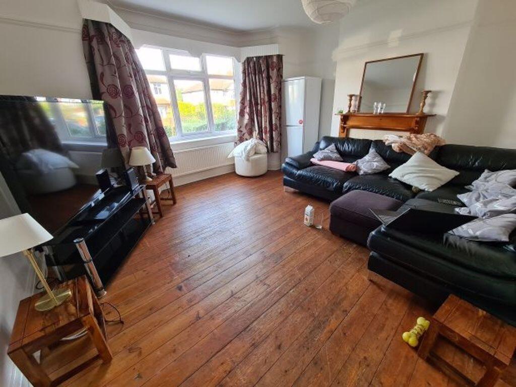 A spacious and well-lit living room featuring c...