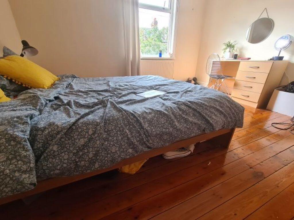 A cozy bedroom featuring a comfortable double b...