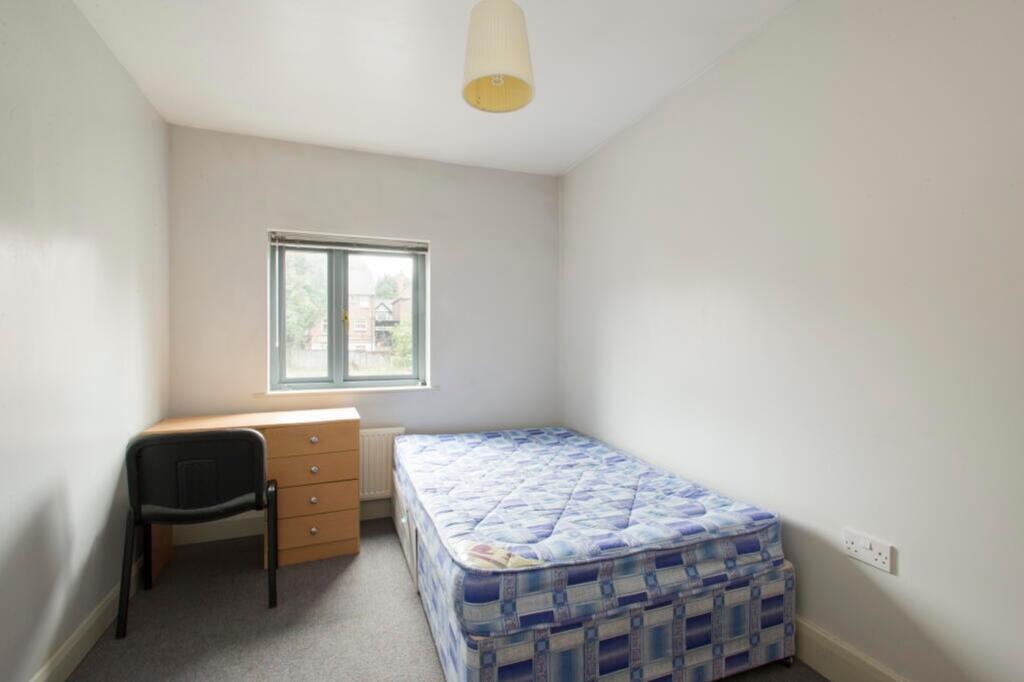 A cozy double bedroom featuring a comfortable b...