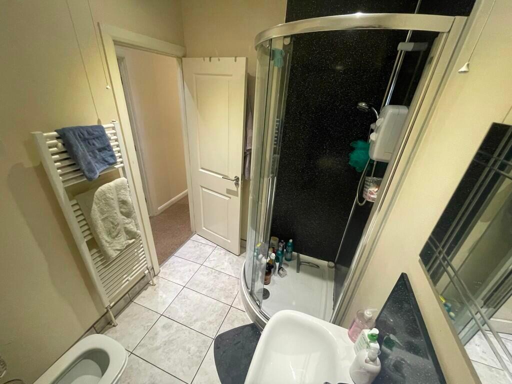 A clean and modern bathroom featuring a curved ...