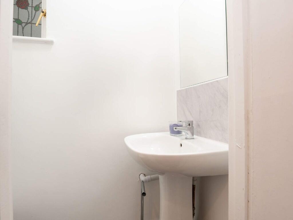 Bright and clean single toilet with a modern wh...