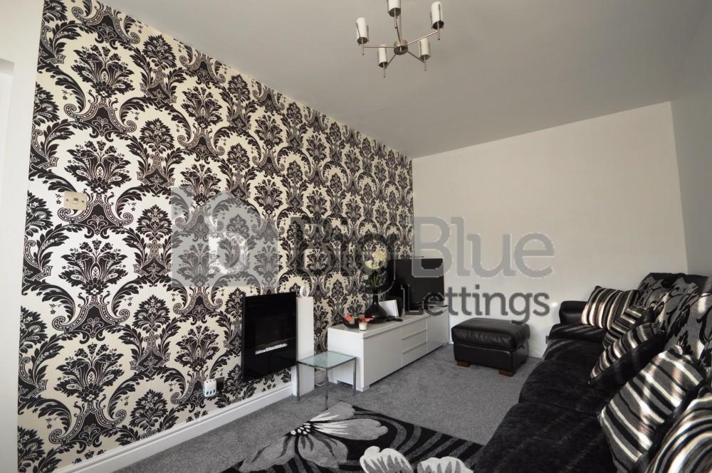 A stylish living room featuring a bold patterne...