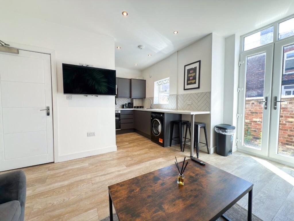 Bright modern open-plan living area with wooden...