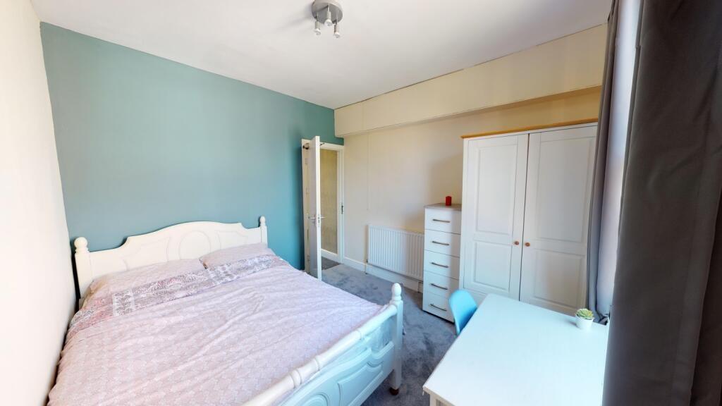 Bright and tidy double bedroom featuring a comf...