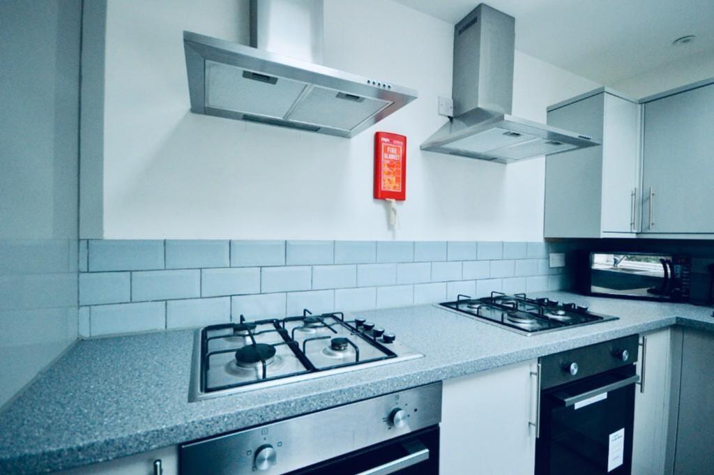 A modern and clean kitchenette featuring contem...