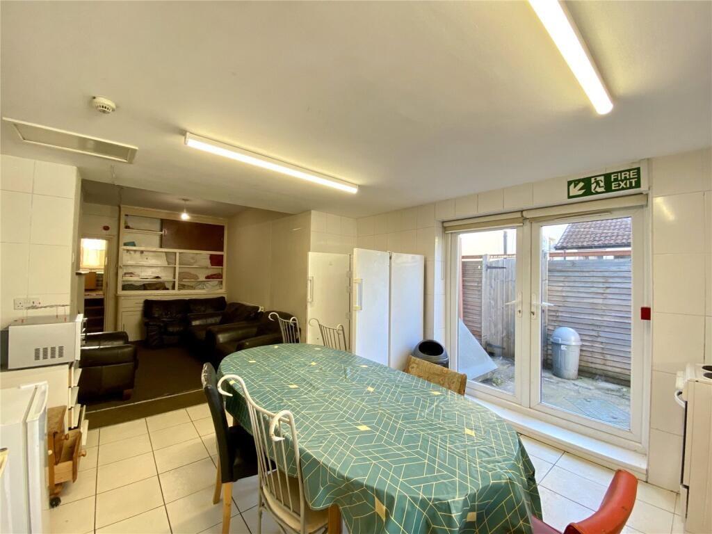 A bright kitchen featuring a dining table cover...