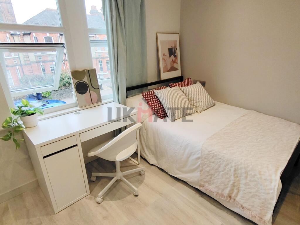 A bright, neatly organized bedroom featuring a ...