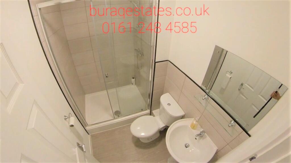 A neat and modern bathroom featuring a white si...