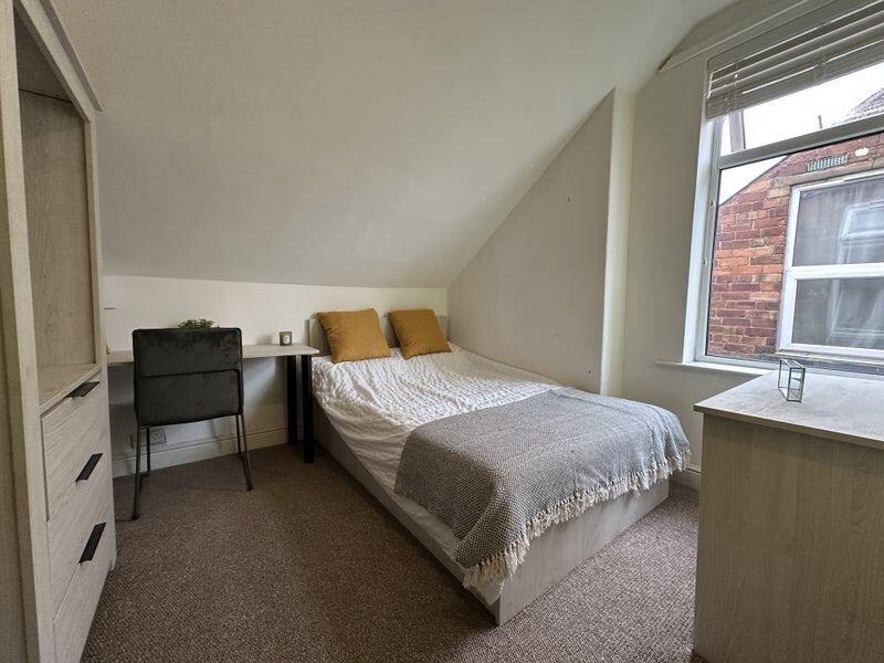 Cozy double bedroom featuring a comfortable bed...