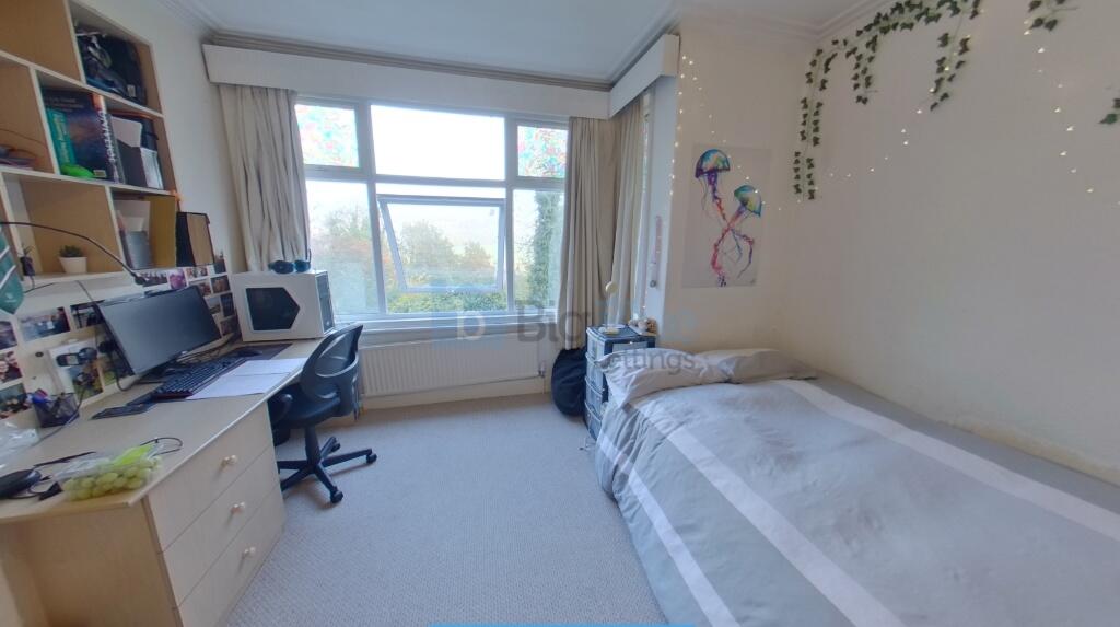 Bright and tidy single bedroom featuring a larg...