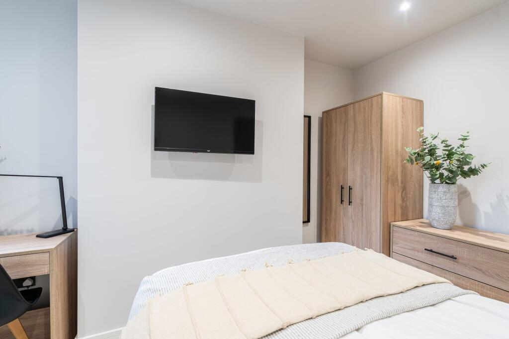 Bright and modern bedroom featuring a comfortab...