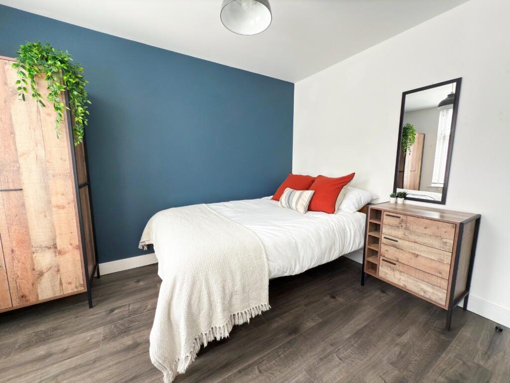 A bright and spacious master bedroom featuring ...