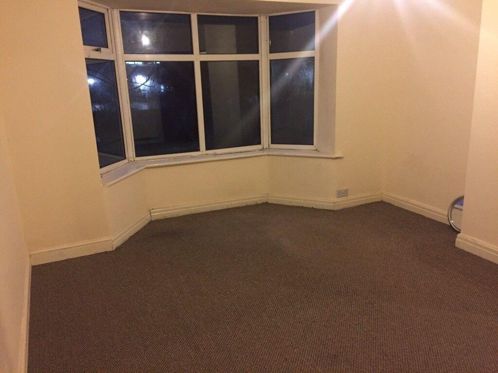 Bright bedroom with a wide bay window, neutral ...