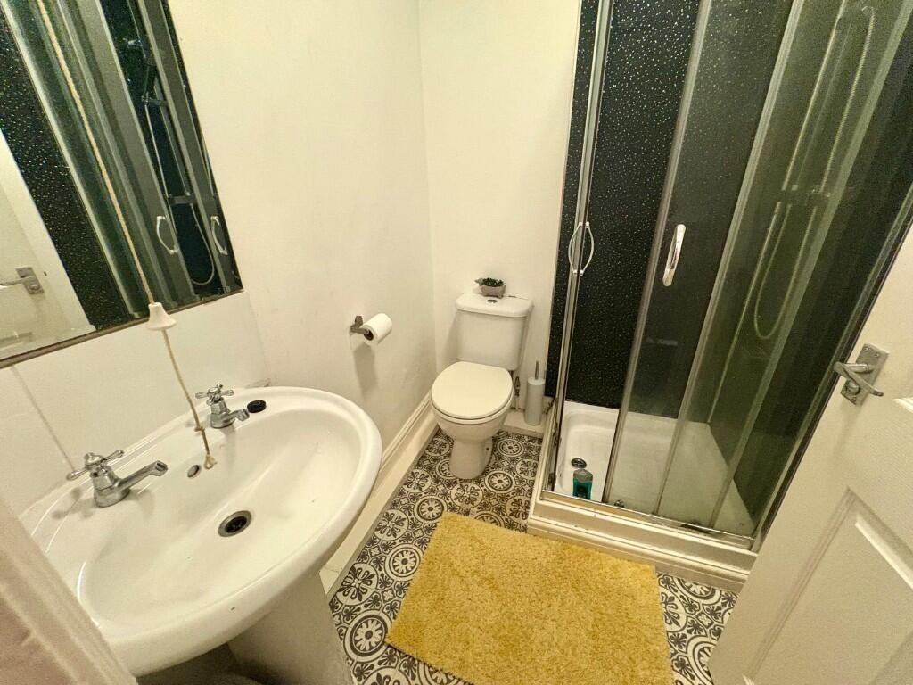 A compact and clean bathroom featuring a white ...