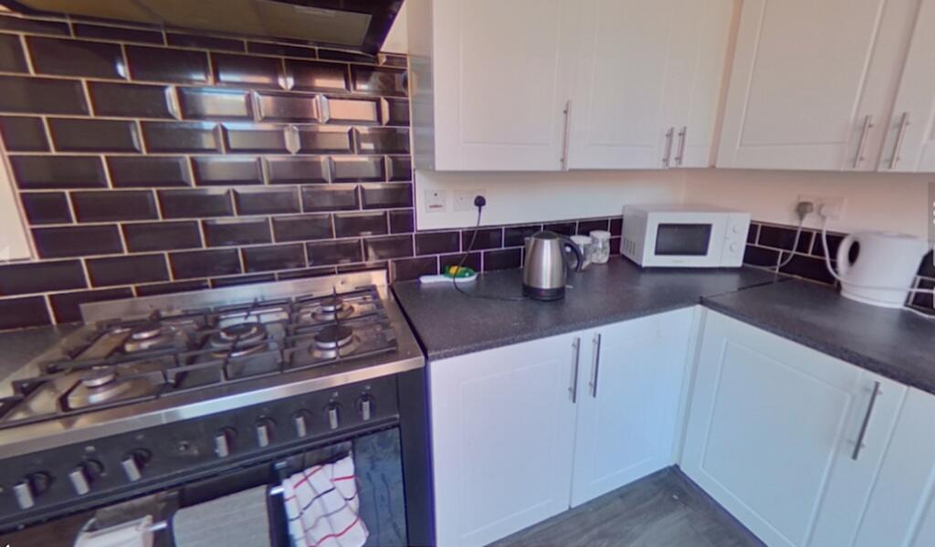 Bright and modern kitchen featuring sleek black...