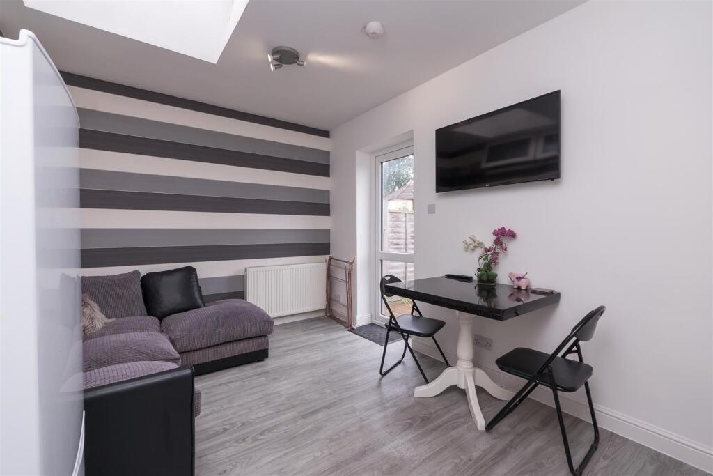Contemporary living room featuring stylish stri...