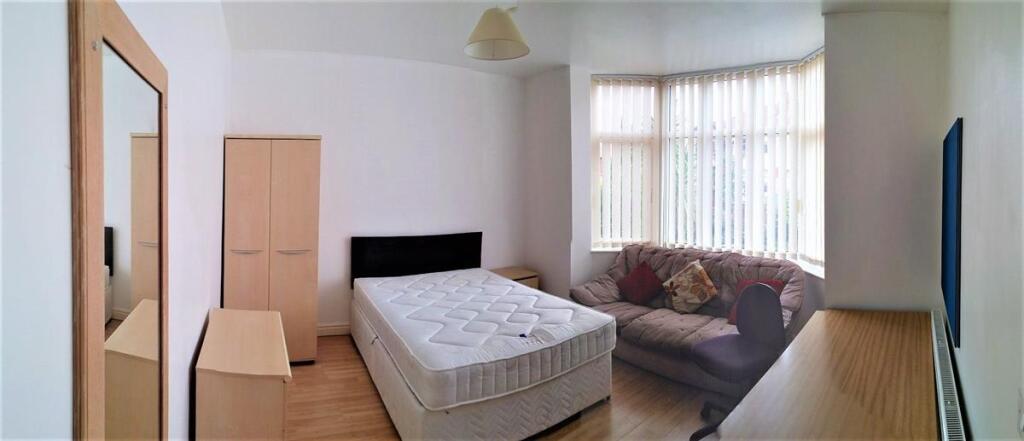 Bright double bedroom featuring a comfortable b...