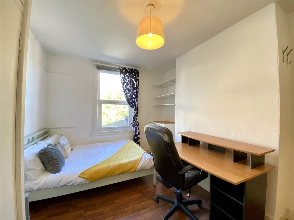 A bright and tidy single bedroom featuring a co...