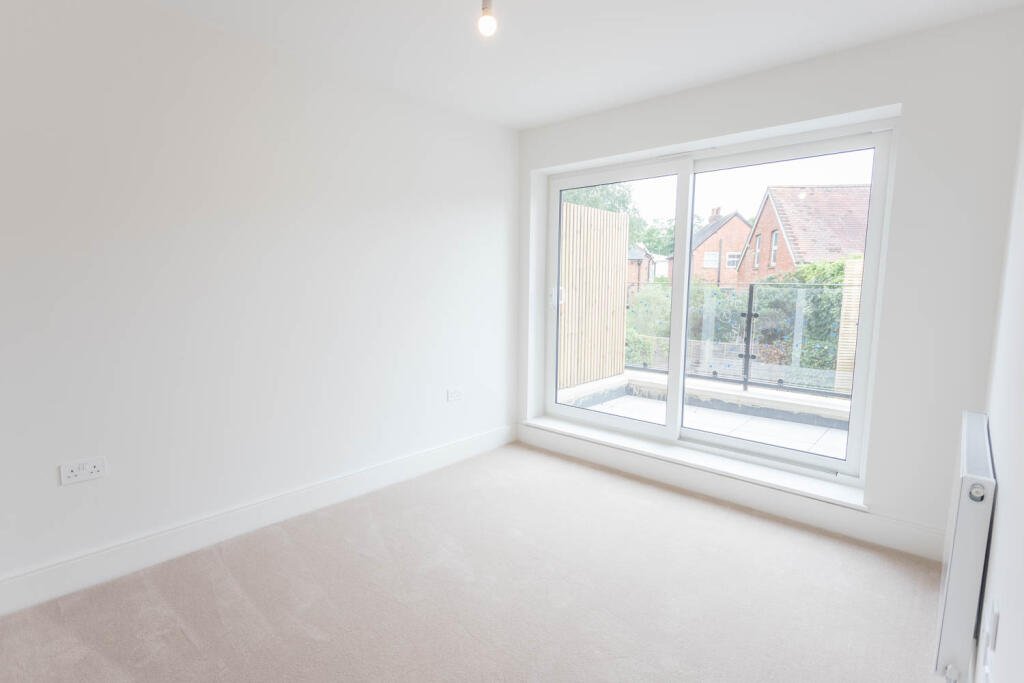 Bedroom with doors opening onto balcony