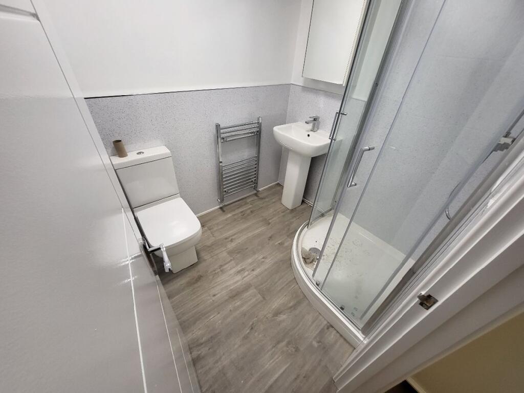 A modern bathroom featuring a sleek shower cubi...