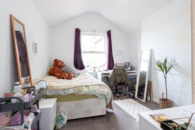 Bright and tidy bedroom featuring a cozy single...