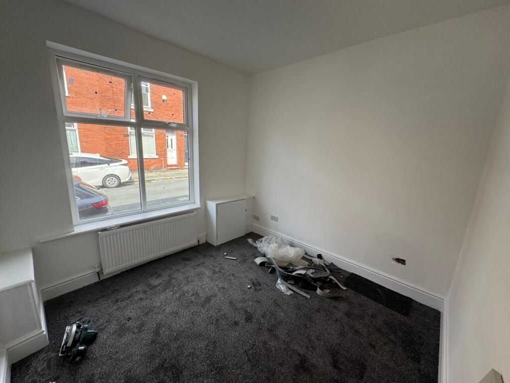 A small, bright room with a large window provid...