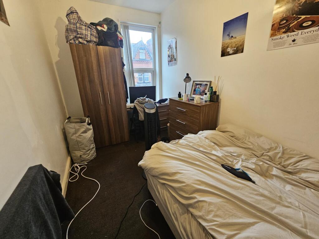 A comfortable student bedroom featuring a singl...