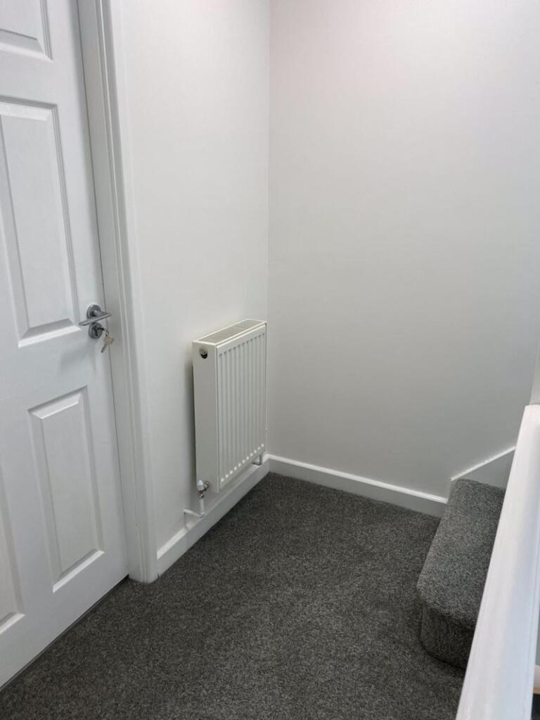 A clean and well-maintained hallway featuring n...