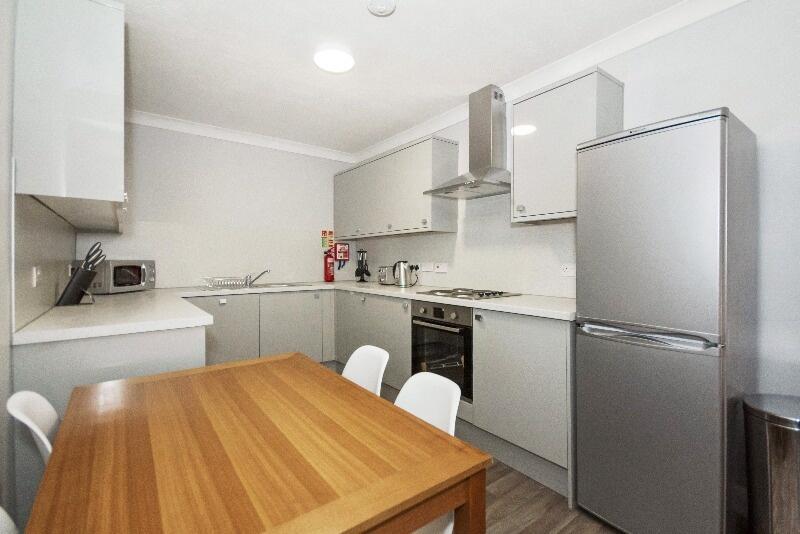 Bright and modern kitchen featuring sleek white...