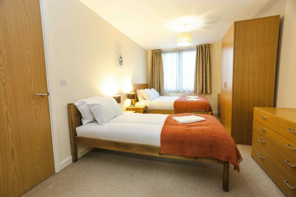 A bright and inviting double bedroom featuring ...