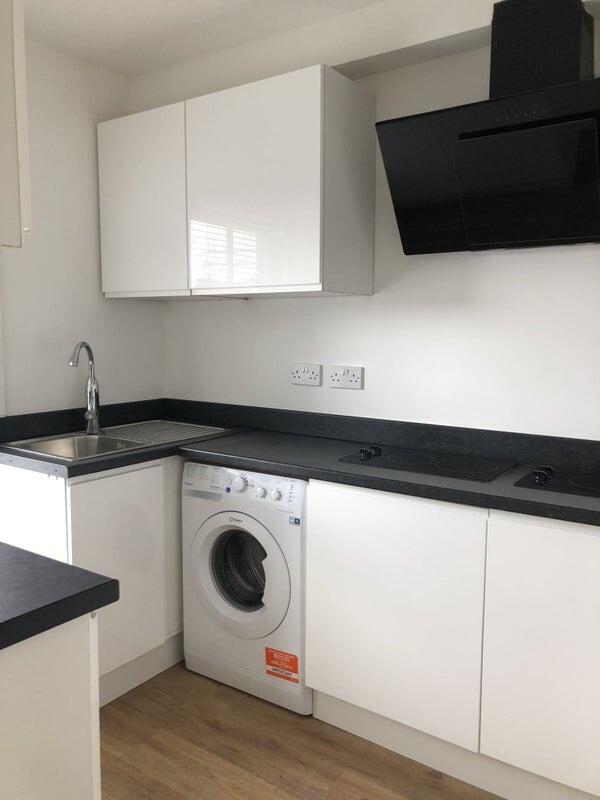 Bright and modern kitchen featuring sleek white...