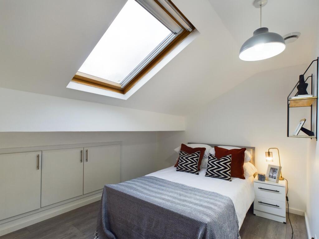 A bright and inviting double bedroom featuring ...