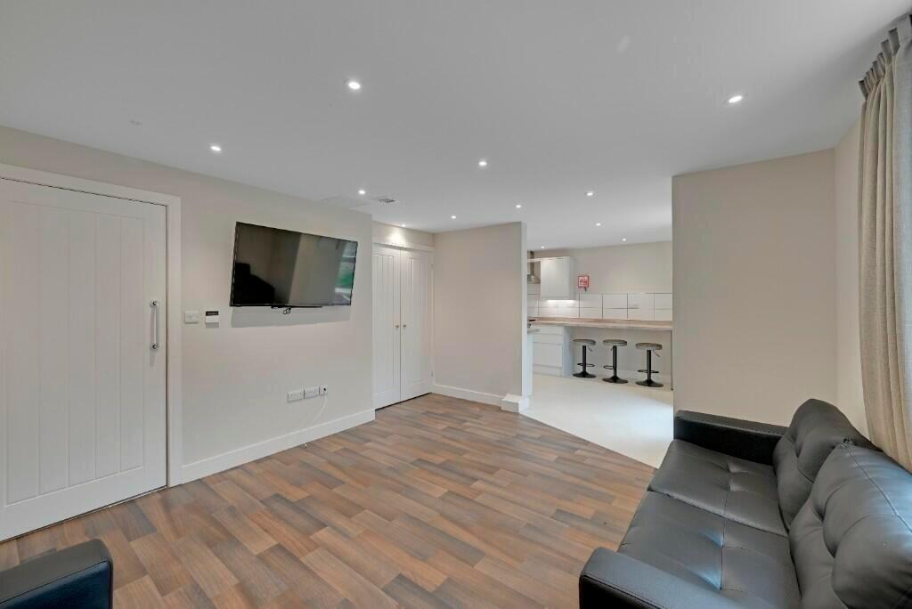 A modern living room featuring sleek wooden flo...