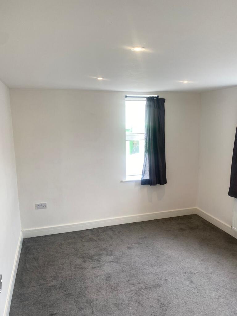 Bright, freshly painted bedroom with recessed c...