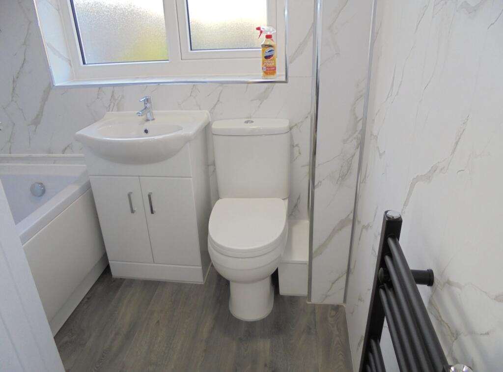 A bright and clean bathroom featuring modern fi...