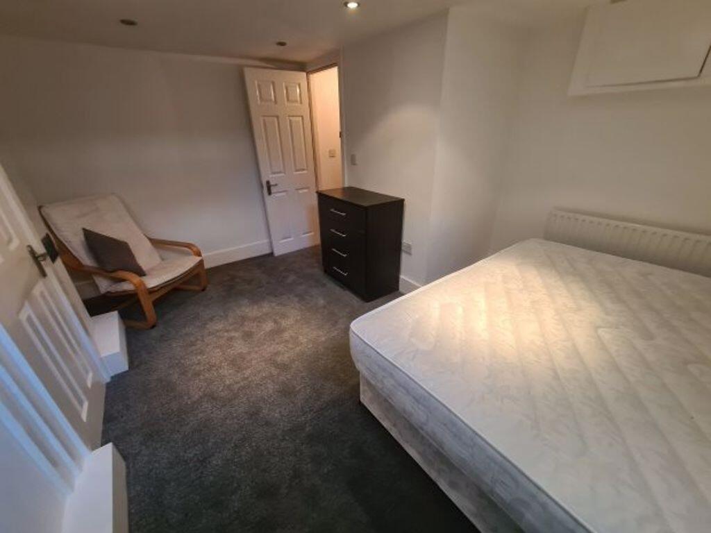 A cozy double bedroom featuring a comfortable d...
