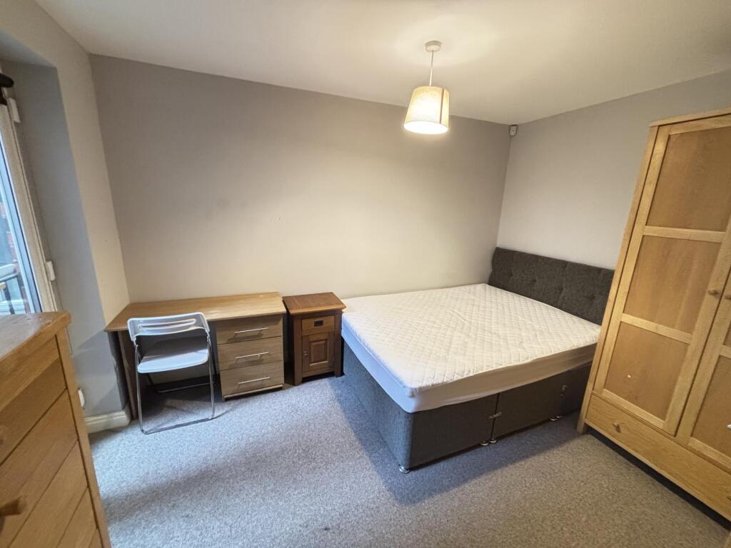 A well-maintained bedroom featuring a double be...