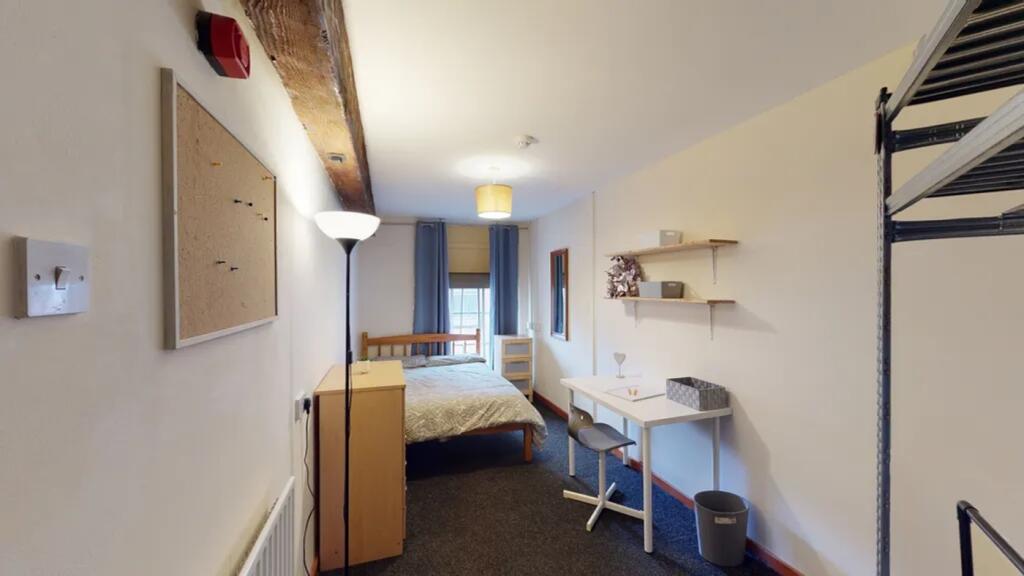 A spacious and well-lit double bedroom featurin...