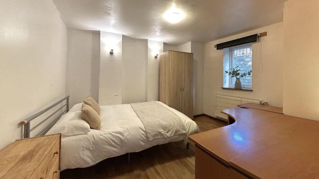 A cozy bedroom featuring a comfortable double b...