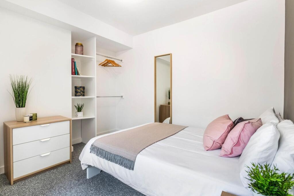A bright and spacious master bedroom featuring ...