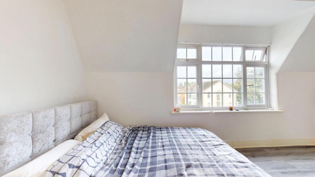 A bright and inviting double bedroom featuring ...