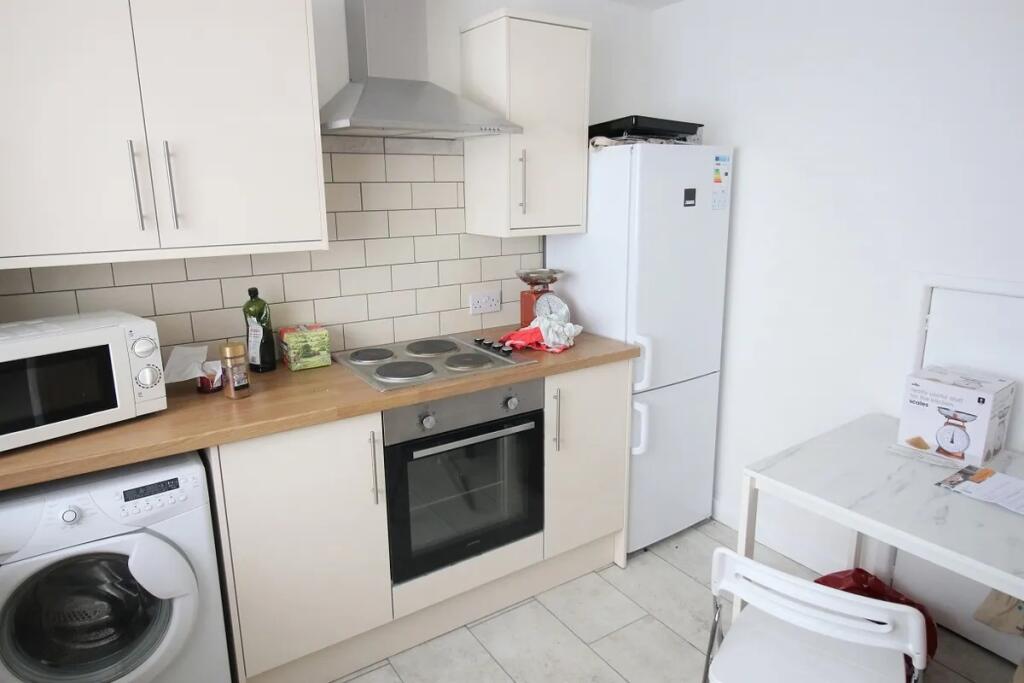 Bright and clean kitchen featuring modern appli...