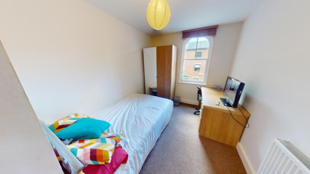 A bright and cozy double bedroom featuring a co...