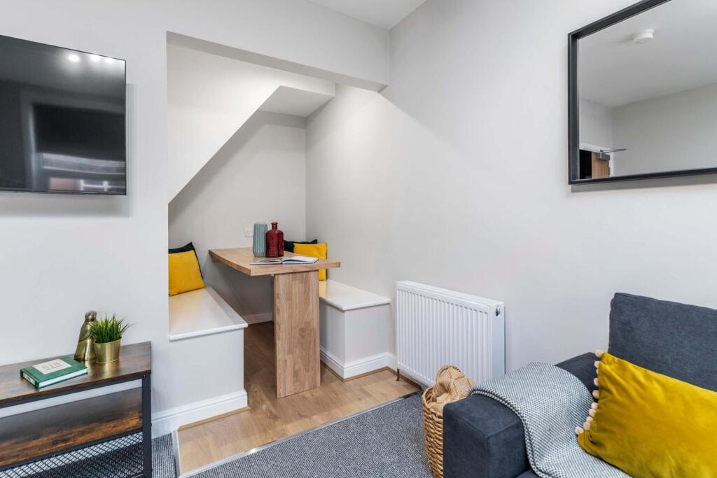 Bright, well-kept living area with a comfortabl...