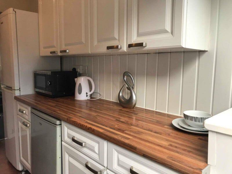 A well-maintained kitchen featuring a spacious ...
