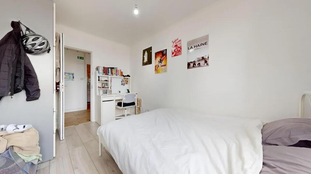 Bright and tidy single bedroom featuring a cozy...