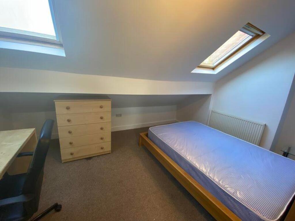 A bright and spacious double bedroom featuring ...