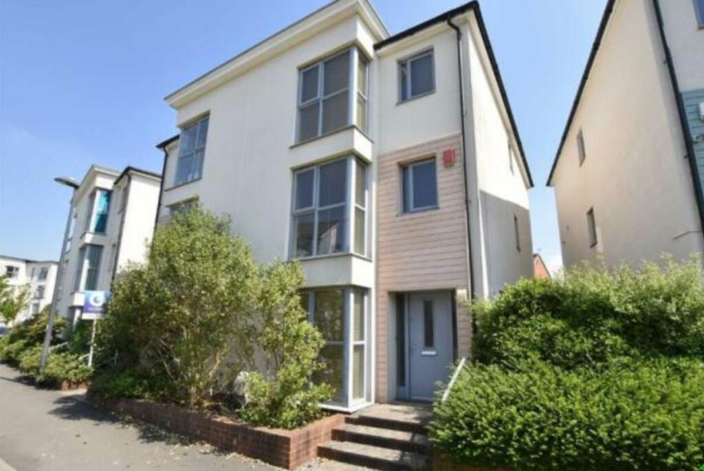 Modern three-storey house with large windows an...
