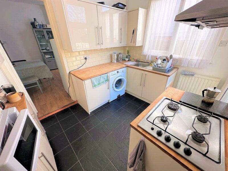 Bright and tidy kitchen featuring modern cream ...