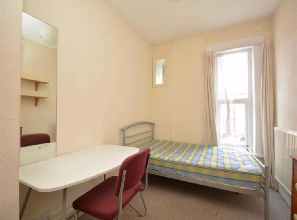 A cozy single bedroom with ample natural light ...